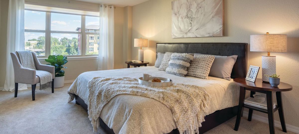 Spacious, furnished main bedroom in two-bedroom apartment.
