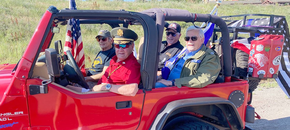 TRIB_Life_0522_Veterans_1610x906 Wind Crest residents in a patriotic Jeep