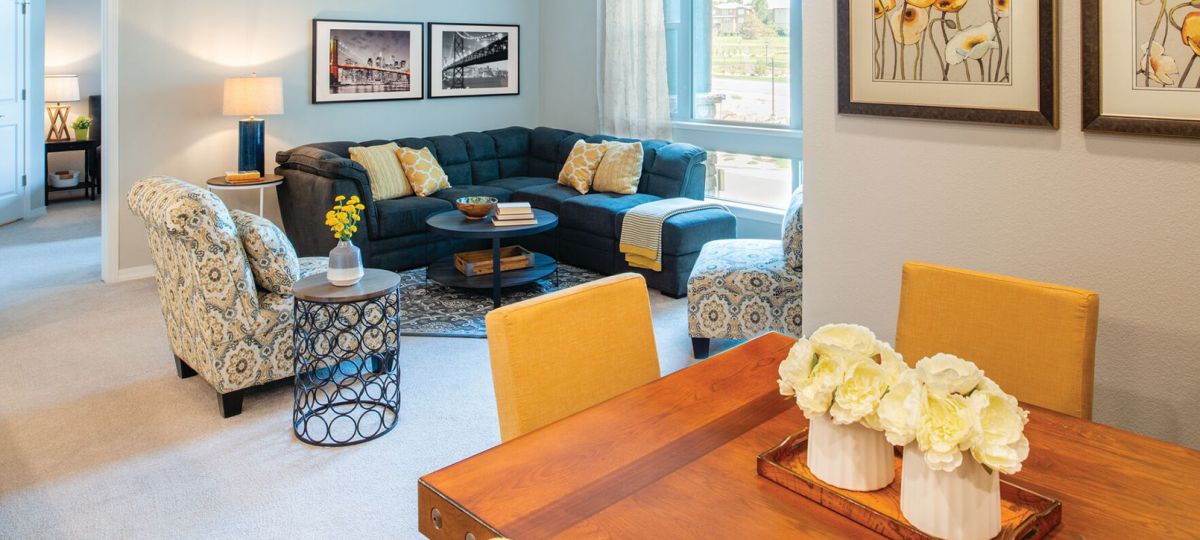 Interior shot of a nicely decorated, open living room in an Erickson one-bedroom apartment home.