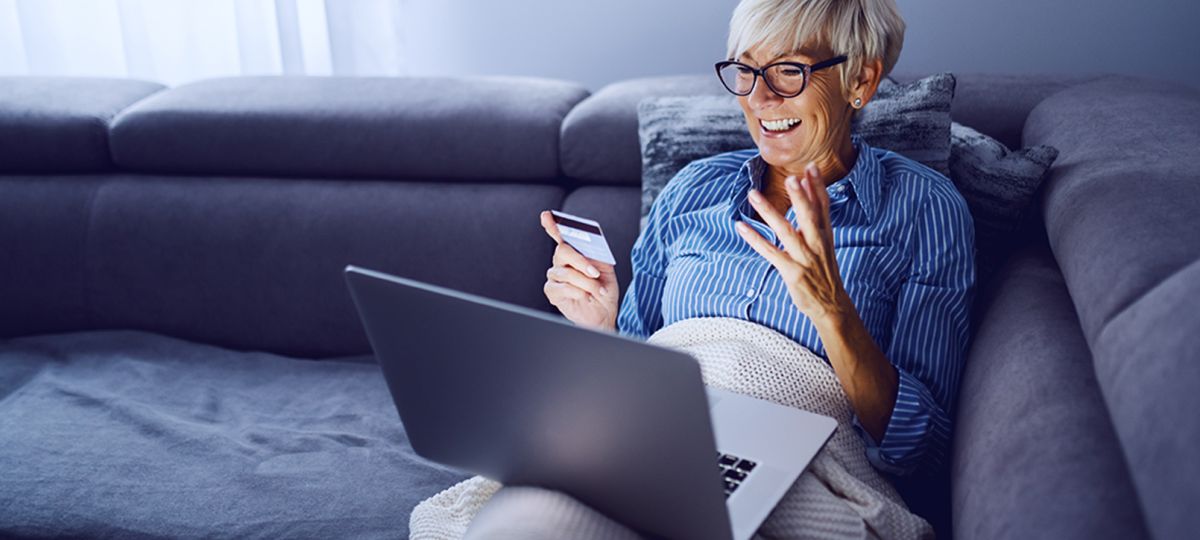 oman with credit card on laptop woman with credit card on laptop