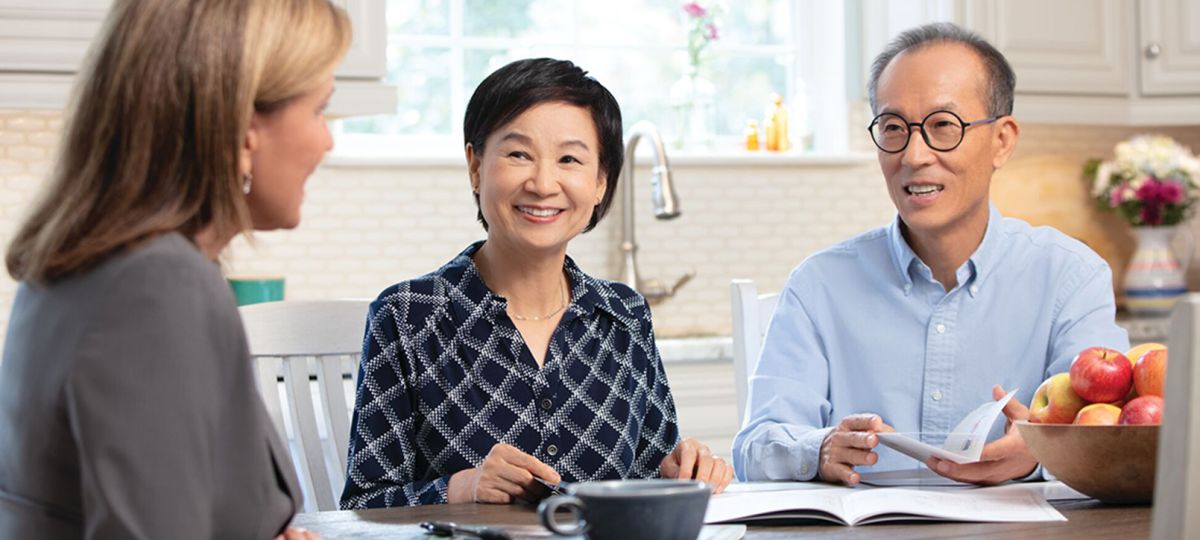 Couple meeting at kitchen table Couple meeting at kitchen table