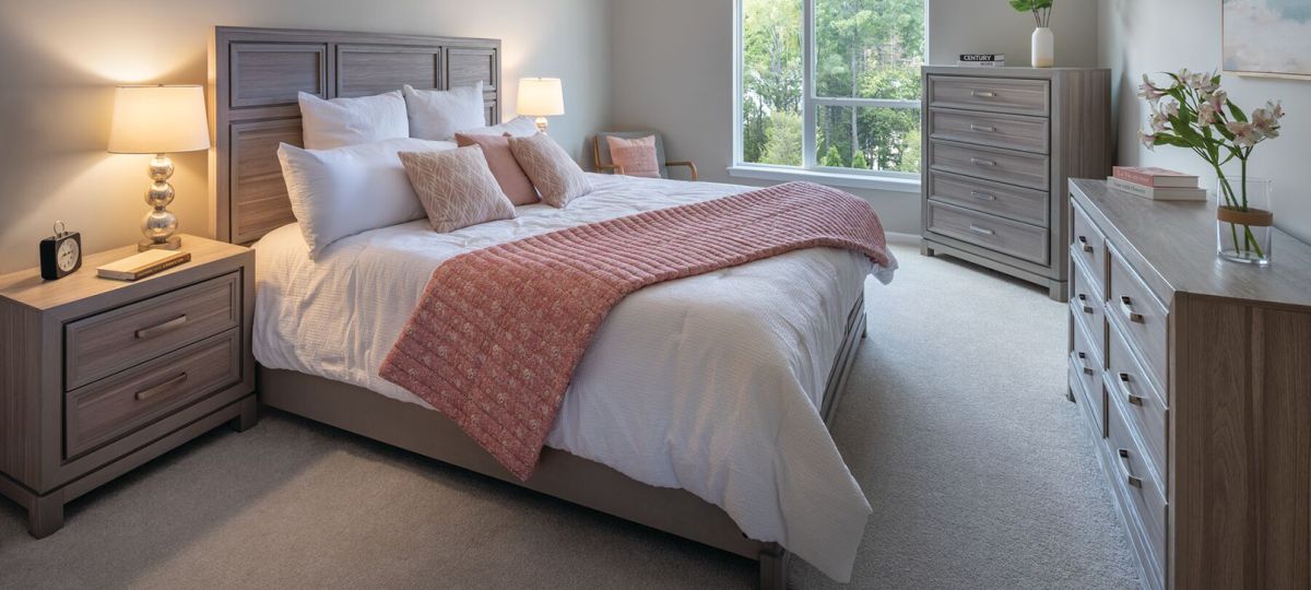 Interior shot of a cozy master bedroom in the Maplewood apartment.