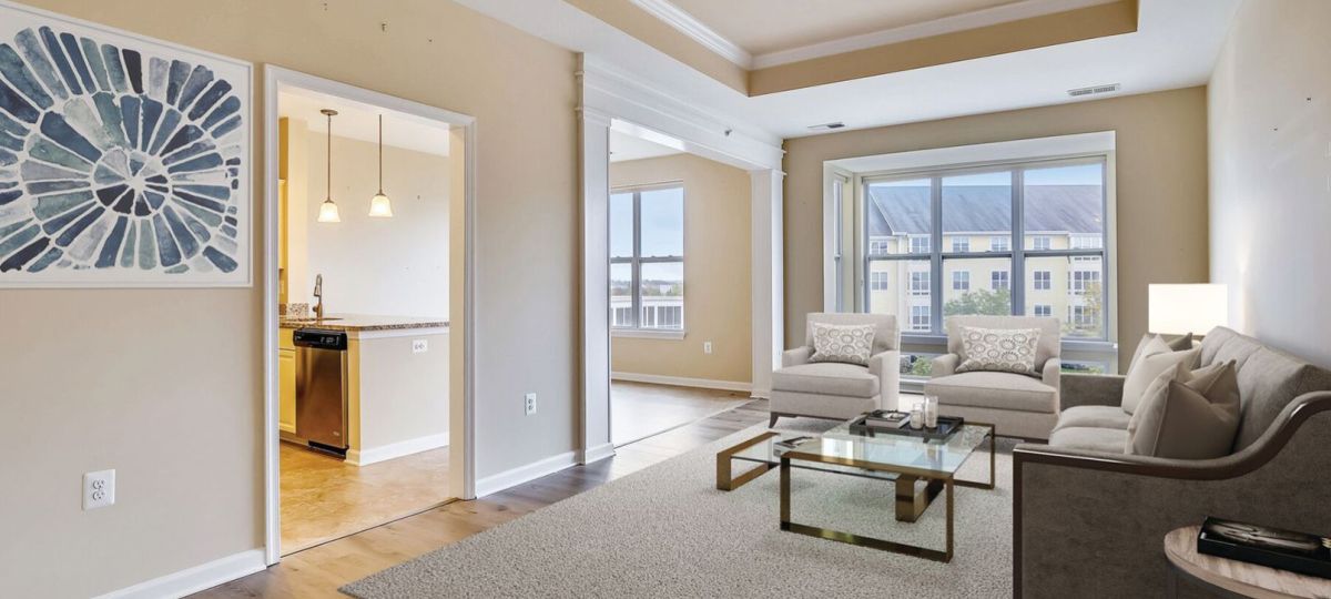 Wide shot of an open, sunny, living room in an one-bedroom apartment.