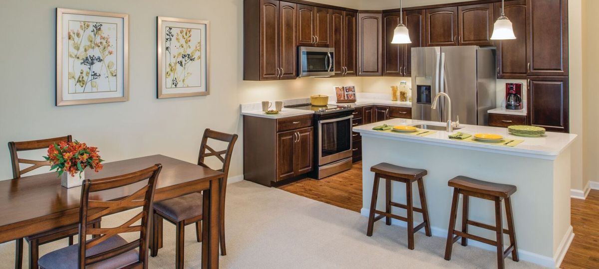 Wide shot of dining room and spacious, open living room.