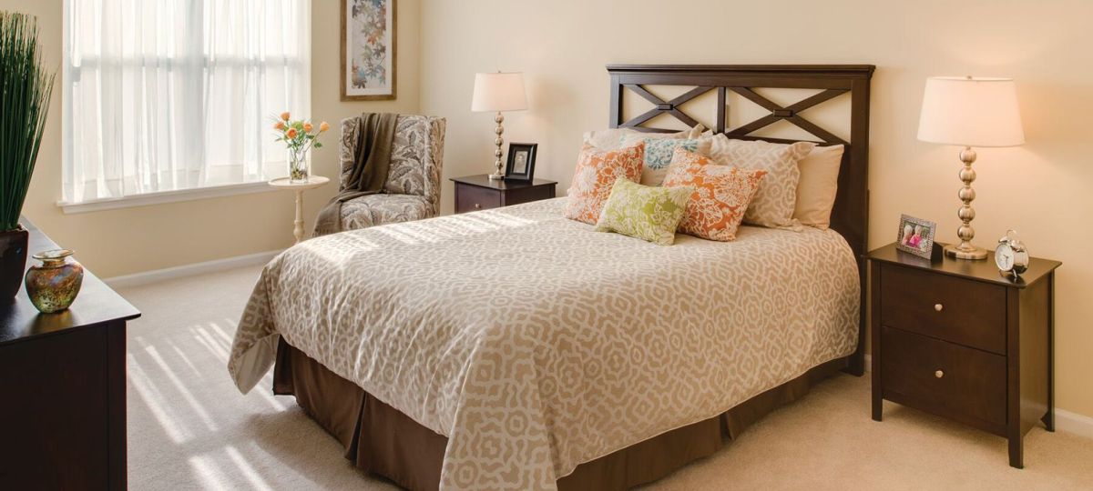 Spacious bedroom with modern furniture and decorations in an Erickson two-bedroom apartment.