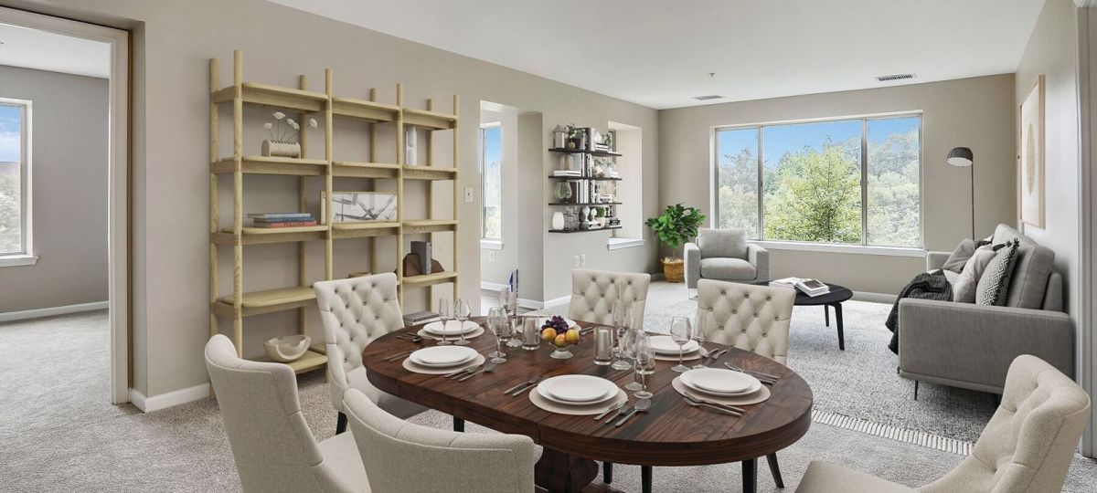 Spacious, light-filled, furnished living room in an Erickson apartment.