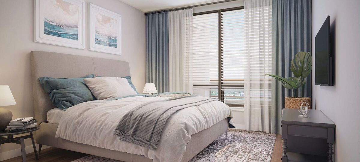 Spacious bedroom with modern furniture and decorations in an Erickson two-bedroom apartment.
