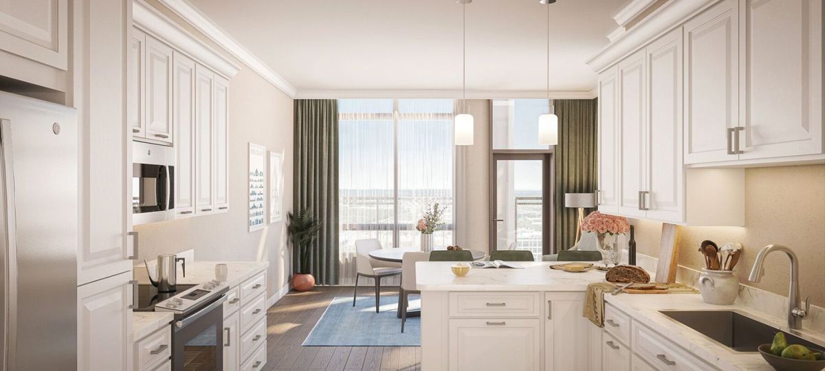 Wide angle shot of a light-filled, furnished living room in an Erickson apartment.