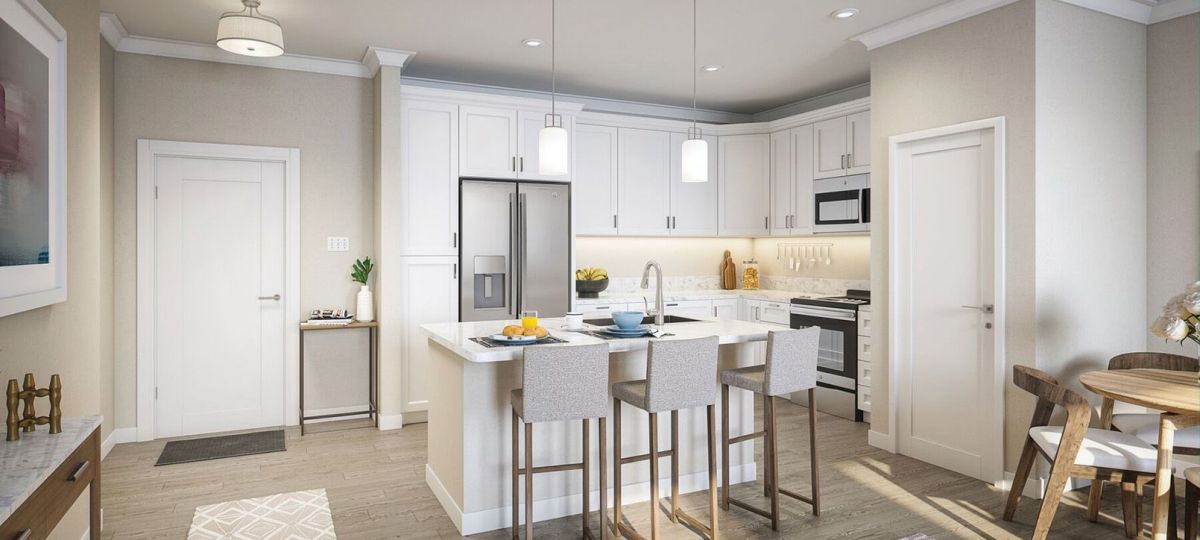 Interior shot of a modern kitchen with stainless steel appliance and a breakfast bar.