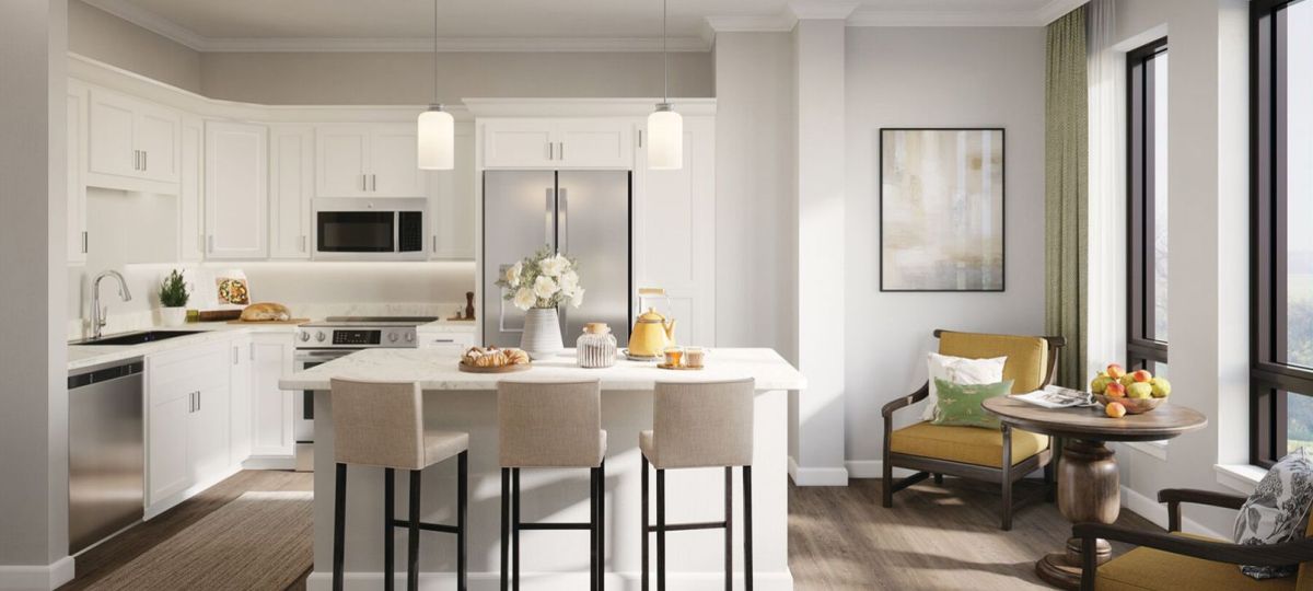 Wide shot of modern kitchen with breakfast bar and seating area.