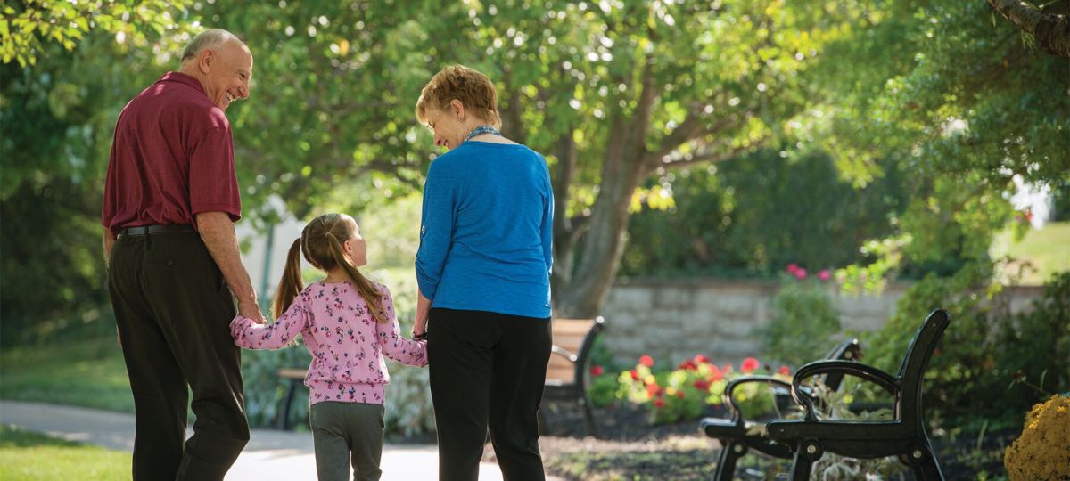 Grandparents walking with child