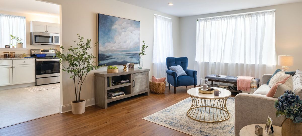 Interior shot of a nicely decorated, spacious living room with hardwood floors in an Erickson apartment.