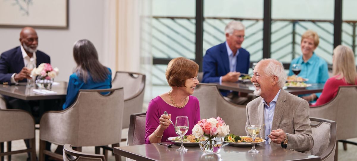 Three tables of diners enjoying their meal.