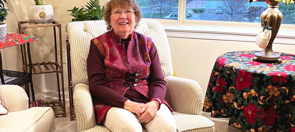resident Miriam Washington sitting in a chair in her apartment home
