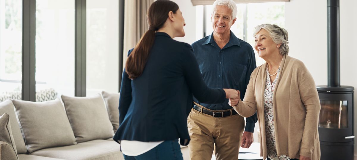 senior couple meeting with planning and moving consultant