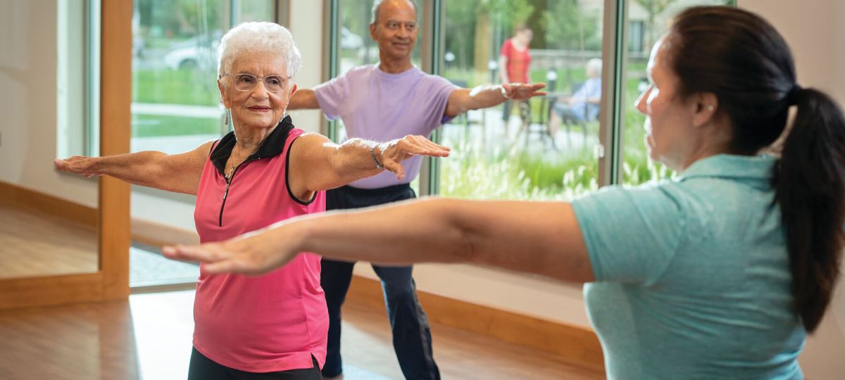 Active seniors participating in a studio fitness class at our vibrant living community.