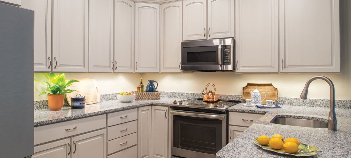 Modern kitchen in an Erickson Senior Living community apartment with stainless steel appliances.