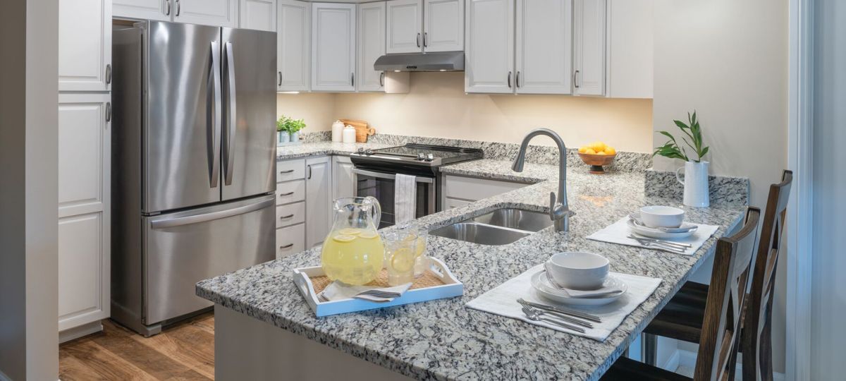Modern kitchen in an Erickson Senior Living community apartment with stainless steel appliances.