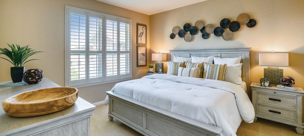 Cozy bedroom in an Erickson Senior Living community apartment with modern furnishings.
