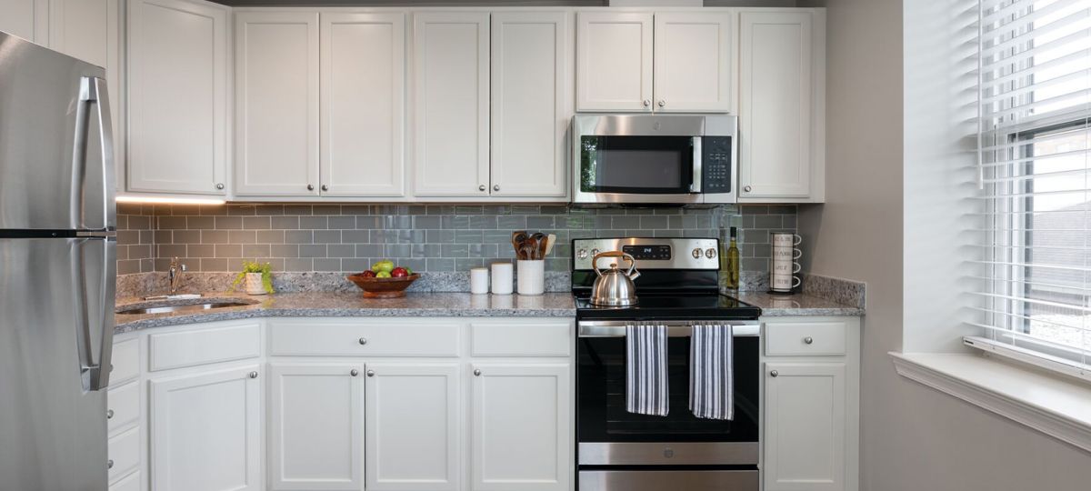 Modern kitchen in an Erickson Senior Living community apartment with stainless steel appliances.