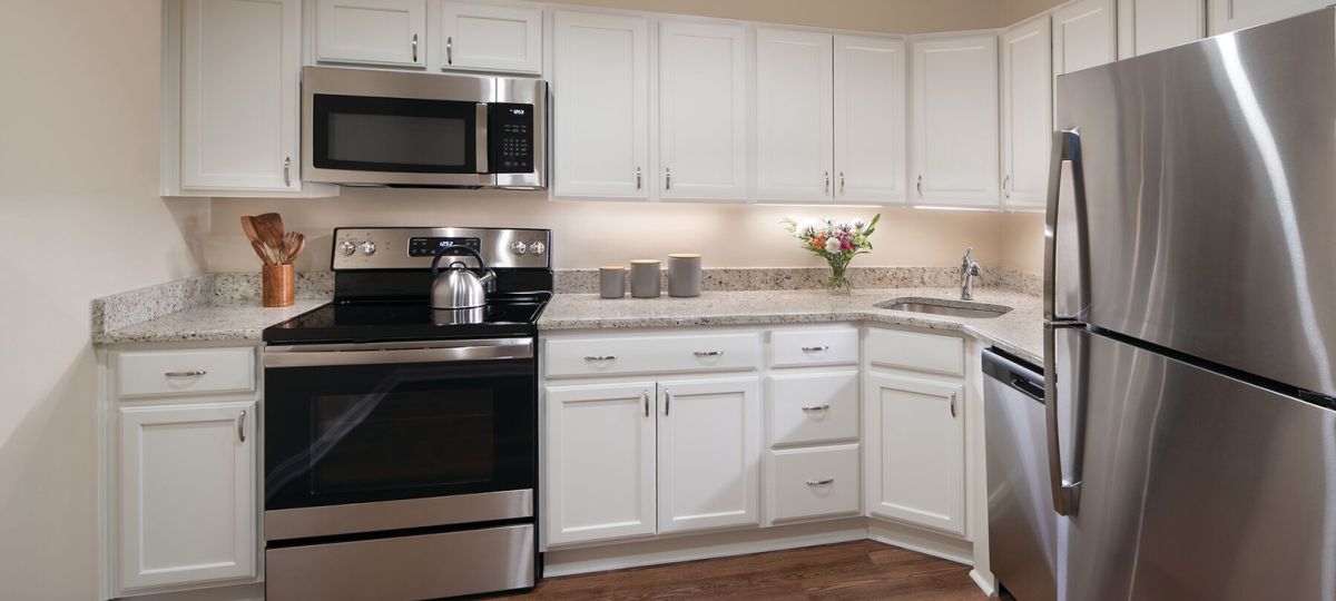 Modern kitchen in an Erickson Senior Living community apartment with stainless steel appliances.