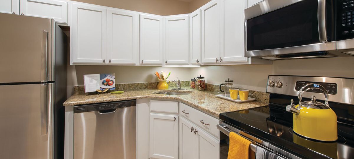 Modern kitchen in an Erickson Senior Living community apartment with stainless steel appliances.