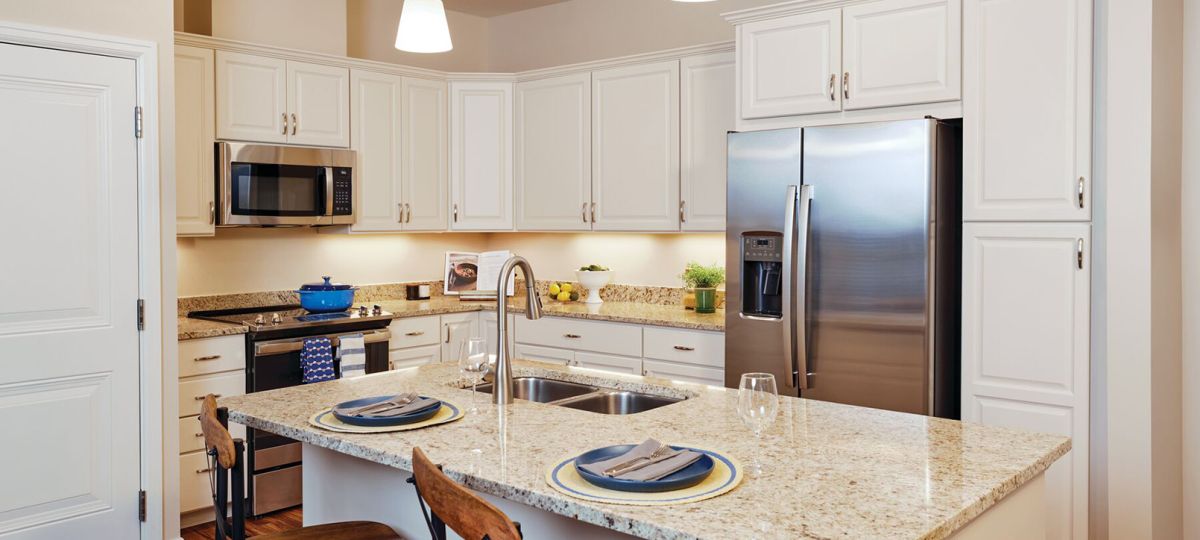 Modern kitchen in an Erickson Senior Living community apartment with stainless steel appliances.
