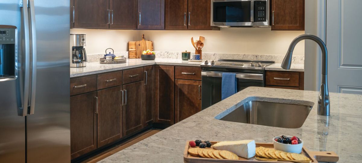 Modern kitchen in an Erickson Senior Living community apartment with stainless steel appliances.