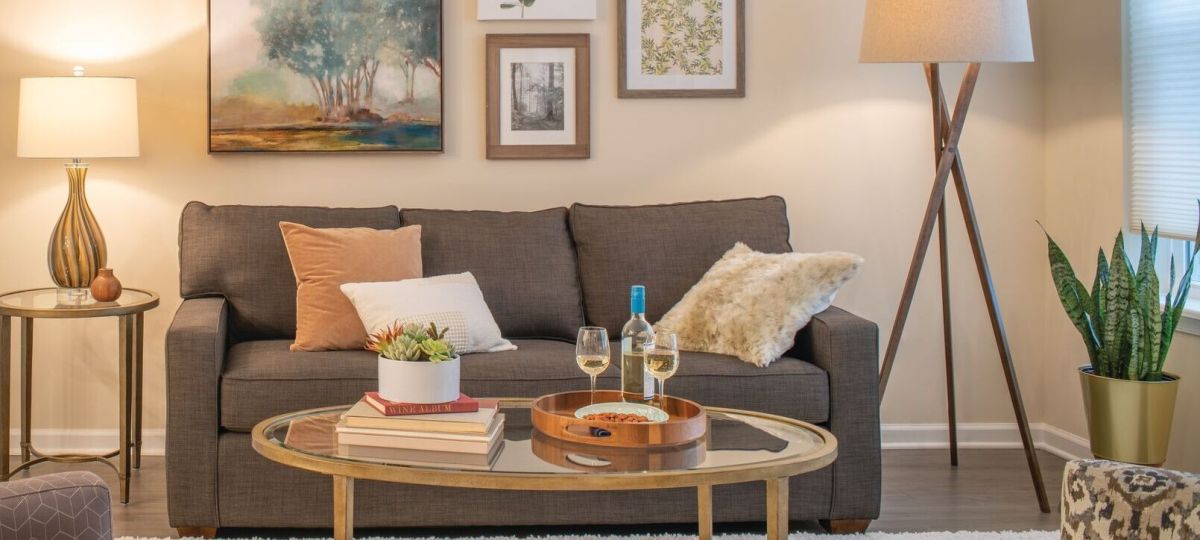 Close-up shot of a modern sofa and wall paintings in a spacious Erickson apartment living room.