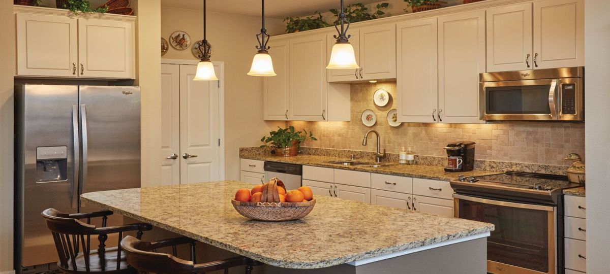 Modern kitchen in an Erickson Senior Living community apartment with stainless steel appliances.