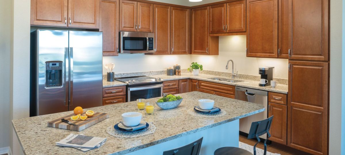 Modern kitchen in an Erickson Senior Living community apartment with stainless steel appliances.