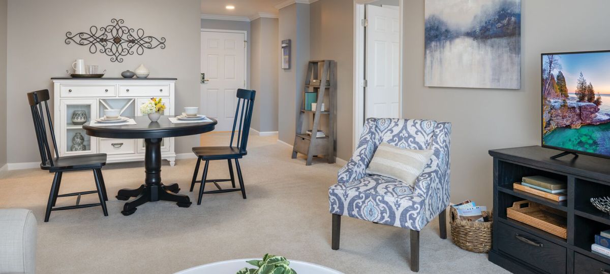 Wide angle shot of a spacious, open living room and dining area in an Erickson apartment.
