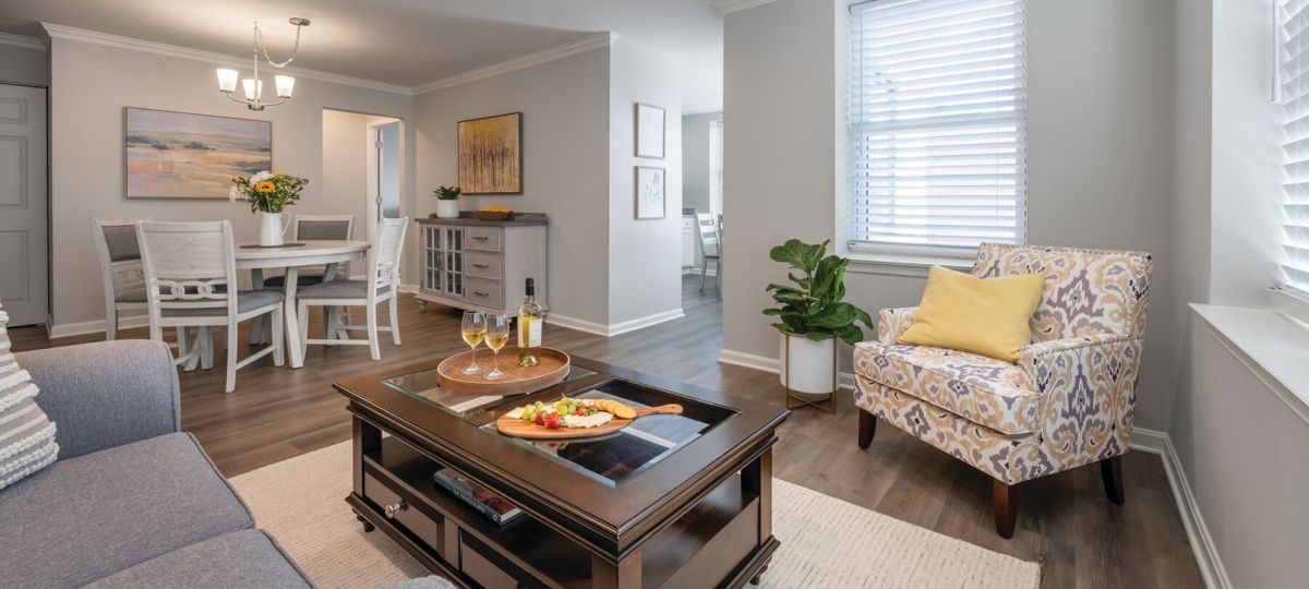 Wide angle shot of a spacious, open living room and dining area in an Erickson apartment.