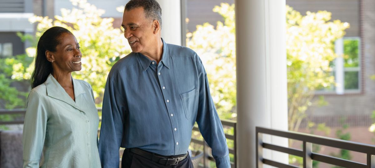 a man and a woman outside holding hands and walking