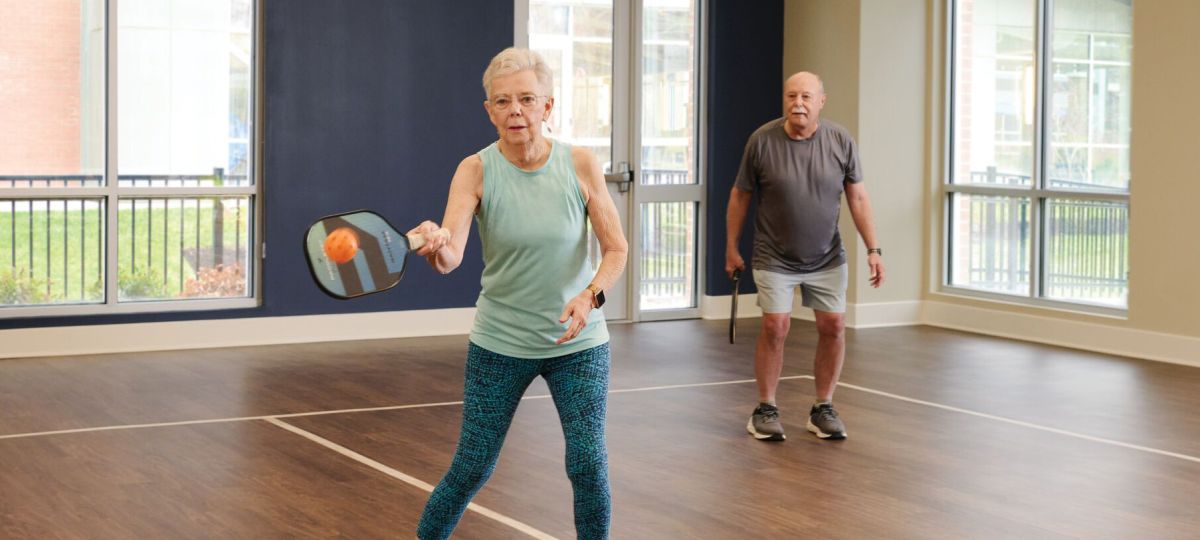 Two residents playing pickleball