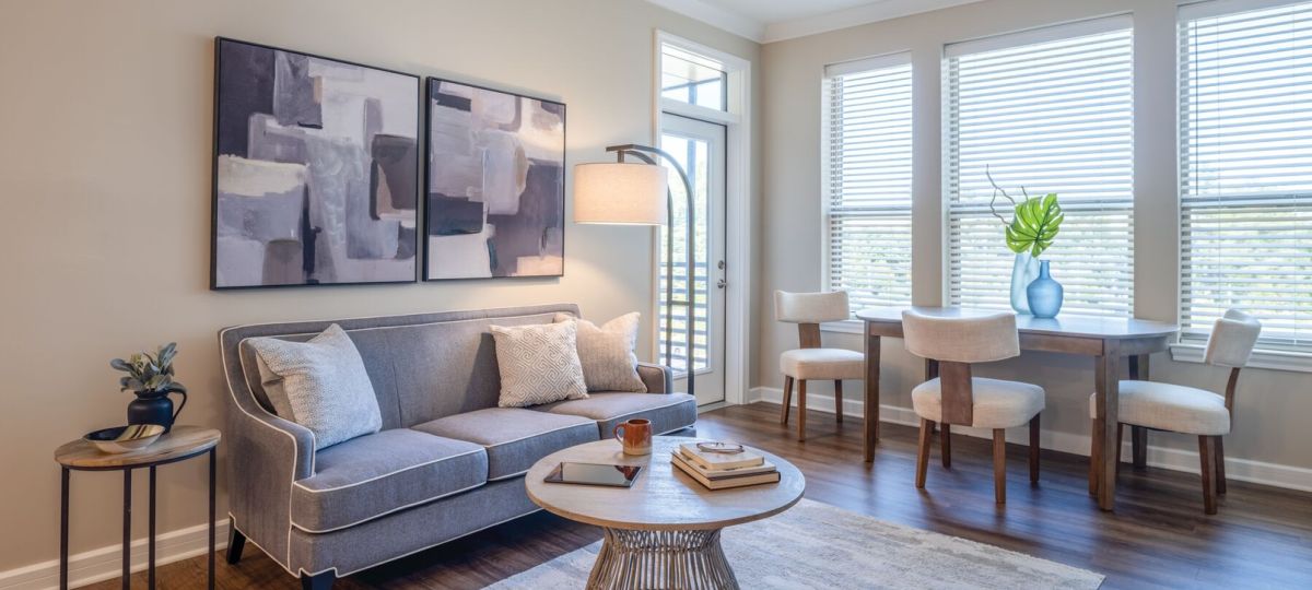 Modern living and dining area with contemporary furniture, wood flooring, and abundant natural light.