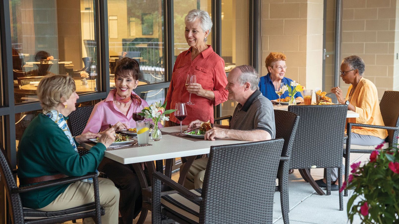 Exterior shot of Erickson residents eating outside on a terrace at one of our restaurants. 