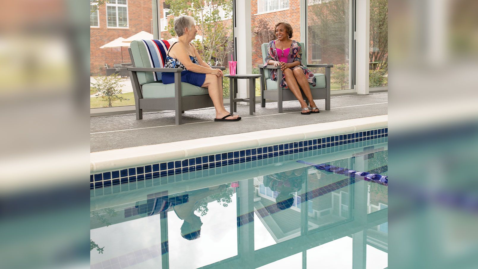 Two residents enjoying an indoor pool