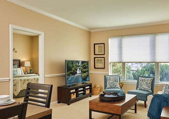 View of living room with large window from the dining area.