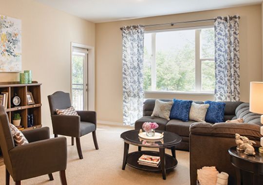 Large living room with styled bookshelf.
