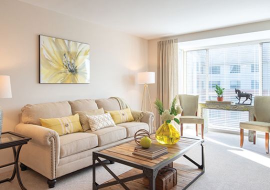 Interior shot of a nicely decorated, open living room in an Erickson two-bedroom apartment home.