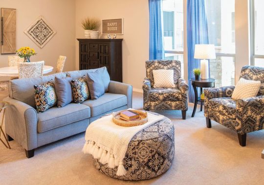Interior shot of a nicely decorated, open living room in an Erickson two-bedroom apartment home.