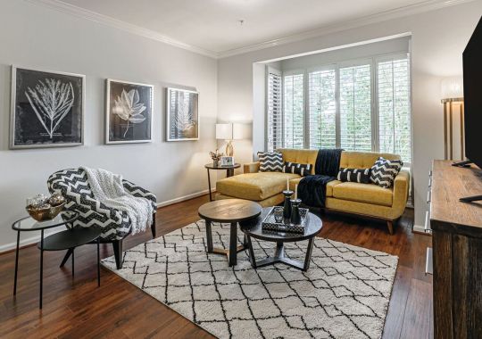 Interior shot of a nicely decorated, open living room in an Erickson two-bedroom apartment home.