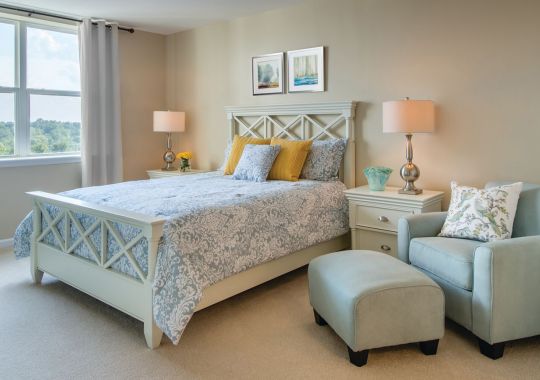 Interior shot of a cozy guest bedroom in an Erickson two-bedroom apartment.