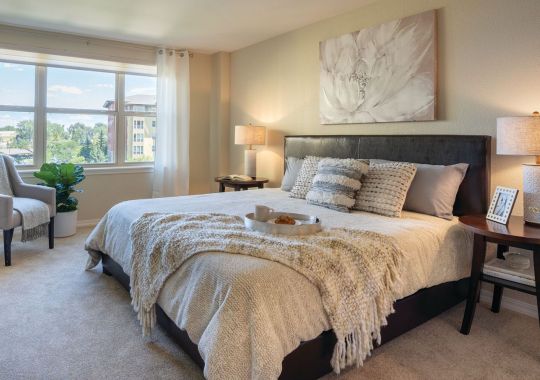 Spacious, furnished main bedroom in two-bedroom apartment.