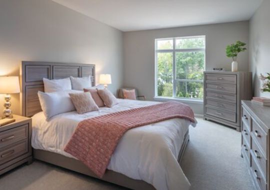 Cozy, furnished, bedroom in the Maplewood apartment.