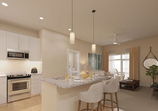 Interior shot of a spacious kitchen and bar with seating inside of an Erickson two-bedroom apartment home.