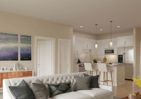 Spacious, furnished, open living room in an Erickson apartment home.