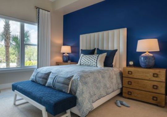 Spacious bedroom with modern furniture and decorations in an Erickson one-bedroom apartment.