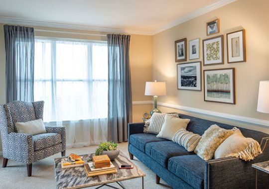 Spacious, furnished, open living room in an Erickson apartment home.